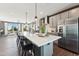 Bright, open kitchen with large island, stainless appliances, modern cabinets, and pendant lighting at 107 Ailey Brook Way # 200, Wake Forest, NC 27587