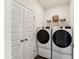 Functional laundry room featuring a side-by-side washer and dryer and double doors at 107 Ailey Brook Way # 200, Wake Forest, NC 27587