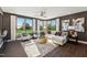 Bright living room with large windows, comfortable seating, and elegant decor, creating an inviting atmosphere at 107 Ailey Brook Way # 200, Wake Forest, NC 27587