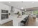 Open kitchen featuring white cabinets, a large island with seating, and stainless steel appliances at 109 Ailey Brook Way # 200, Wake Forest, NC 27587
