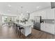 Spacious kitchen with a large island, white cabinets, stainless steel appliances, and hardwood floors at 109 Ailey Brook Way # 200, Wake Forest, NC 27587