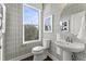 Stylish powder room showcasing patterned wallpaper, a pedestal sink, and a window with natural light at 109 Ailey Brook Way # 200, Wake Forest, NC 27587