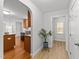 Bright hallway with wood-look flooring and access to kitchen at 1201 Dexter Ridge Dr, Holly Springs, NC 27540