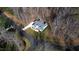 Stunning aerial view of home on large lot nestled among mature trees and paved driveway at 1201 Rivermead Ln, Wake Forest, NC 27587