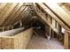 Spacious unfinished attic with wooden beams and plywood flooring for potential expansion at 1201 Rivermead Ln, Wake Forest, NC 27587