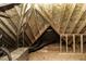 Unfinished attic space with wooden beams and exposed plywood, ready for customization at 1201 Rivermead Ln, Wake Forest, NC 27587