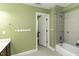 Well-lit bathroom with a vanity, tub-shower combo, and neutral tile flooring for easy maintenance at 1201 Rivermead Ln, Wake Forest, NC 27587