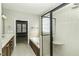 Bathroom featuring a tub, shower with glass door, and vanity with ample storage, with a pass-through to another room at 1201 Rivermead Ln, Wake Forest, NC 27587