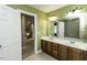 Bright bathroom featuring a double vanity, tile floors, and a combination shower and tub at 1201 Rivermead Ln, Wake Forest, NC 27587