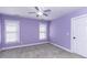 This bright bedroom features purple walls and a ceiling fan at 1201 Rivermead Ln, Wake Forest, NC 27587