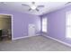 Cozy bedroom featuring lilac walls, a ceiling fan, and access to an attached bathroom at 1201 Rivermead Ln, Wake Forest, NC 27587