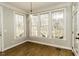 Breakfast nook surrounded by large windows, offering natural light and wooded views at 1201 Rivermead Ln, Wake Forest, NC 27587