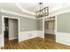 Dining area with hardwood floors, detailed trim, and modern light fixture at 1201 Rivermead Ln, Wake Forest, NC 27587