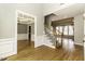 Open foyer featuring hardwood floors, wainscoting, and a staircase with carpeted treads at 1201 Rivermead Ln, Wake Forest, NC 27587