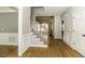Bright foyer with hardwood floors, wainscoting, and a staircase with carpeted treads at 1201 Rivermead Ln, Wake Forest, NC 27587