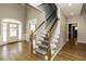 Inviting foyer featuring a staircase with hardwood floors, natural light, and neutral paint at 1201 Rivermead Ln, Wake Forest, NC 27587