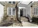 Close up of a home's entry, showing stone detail, and a black front door at 1201 Rivermead Ln, Wake Forest, NC 27587