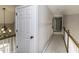 Upstairs hallway with a decorative chandelier and natural lighting creates an inviting transition between rooms at 1201 Rivermead Ln, Wake Forest, NC 27587