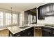 Stylish kitchen featuring granite countertops, dark cabinets and stainless steel dishwasher at 1201 Rivermead Ln, Wake Forest, NC 27587