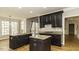 Kitchen boasting dark wood cabinets, granite countertops, and stainless steel appliances at 1201 Rivermead Ln, Wake Forest, NC 27587