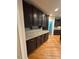 Kitchen boasts granite counters and dark wood cabinetry with stainless steel pulls at 1201 Rivermead Ln, Wake Forest, NC 27587