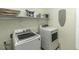 Functional laundry room with washer, dryer, and shelving for storage at 1201 Rivermead Ln, Wake Forest, NC 27587