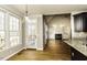 Open-concept living area with wood floors, fireplace, built-ins, and views to the outdoors at 1201 Rivermead Ln, Wake Forest, NC 27587