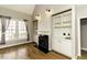 Bright living room featuring a fireplace, built-in shelving, and large windows with natural light and hardwood floors at 1201 Rivermead Ln, Wake Forest, NC 27587