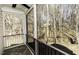 Screened porch with serene views of the surrounding trees and landscaping at 1201 Rivermead Ln, Wake Forest, NC 27587