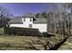 Rear exterior view of home, with mature landscaping, and mature trees at 1201 Rivermead Ln, Wake Forest, NC 27587