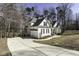 View of home featuring an attached garage, concrete driveway, manicured landscaping, and mature trees at 1201 Rivermead Ln, Wake Forest, NC 27587