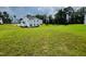 Large backyard with green grass and a view of neighboring houses at 1312 Anthony Wood Ct, Fuquay Varina, NC 27526