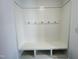 White coat closet with bench and hooks at 1312 Anthony Wood Ct, Fuquay Varina, NC 27526