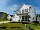 Two-story white house with a two-car garage and landscaped yard at 1312 Anthony Wood Ct, Fuquay Varina, NC 27526