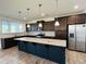 Open concept kitchen with dark cabinetry and granite island at 1312 Anthony Wood Ct, Fuquay Varina, NC 27526