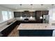 Island kitchen with granite countertops and stainless steel appliances at 1312 Anthony Wood Ct, Fuquay Varina, NC 27526