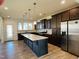 Spacious kitchen featuring an island and stainless steel refrigerator at 1312 Anthony Wood Ct, Fuquay Varina, NC 27526
