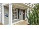 Inviting front entrance with a black door, star accents, and a covered porch at 1315 Legacy Greene Ave, Wake Forest, NC 27587