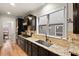 Kitchen with granite counters, dark cabinets, and stainless steel appliances at 1501 Lincoln Mill Dr, Durham, NC 27703