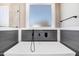 Modern bathroom with free-standing bathtub and gray plank accent wall at 1647 Old Dam Rd, Kenly, NC 27542