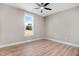 Spacious bedroom with hardwood floors and a large window at 1647 Old Dam Rd, Kenly, NC 27542