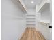 Spacious walk-in closet with ample shelving and hanging rods at 1647 Old Dam Rd, Kenly, NC 27542