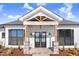 Modern farmhouse front entrance with double doors and stone accents at 1647 Old Dam Rd, Kenly, NC 27542