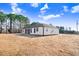 Rear view showcasing house and screened porch at 1647 Old Dam Rd, Kenly, NC 27542
