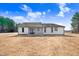 Back of house with screened porch and landscaping at 1647 Old Dam Rd, Kenly, NC 27542