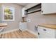 Laundry room with white cabinets, wood countertops, and overhead shelving at 1647 Old Dam Rd, Kenly, NC 27542