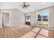 Bright living room with vaulted ceiling, hardwood floors, and large windows at 1647 Old Dam Rd, Kenly, NC 27542