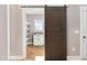 Spacious pantry with white cabinets and sliding barn door at 1647 Old Dam Rd, Kenly, NC 27542