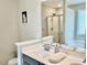 Elegant bathroom with double vanity, a large mirror, and a walk-in shower at 166 Gulley Glen Dr, Garner, NC 27529