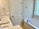 Relaxing bathroom with soaking tub, double vanity, and a separate shower at 166 Gulley Glen Dr, Garner, NC 27529